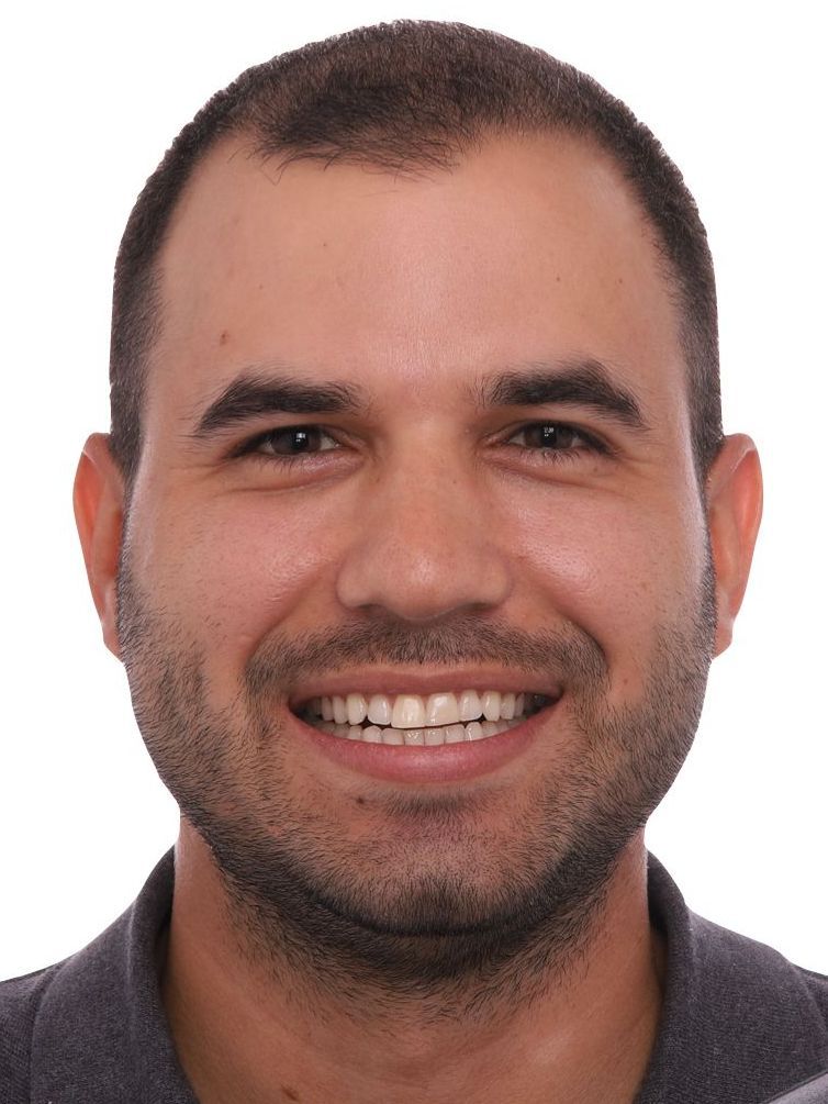 A man with a beard is smiling for the camera