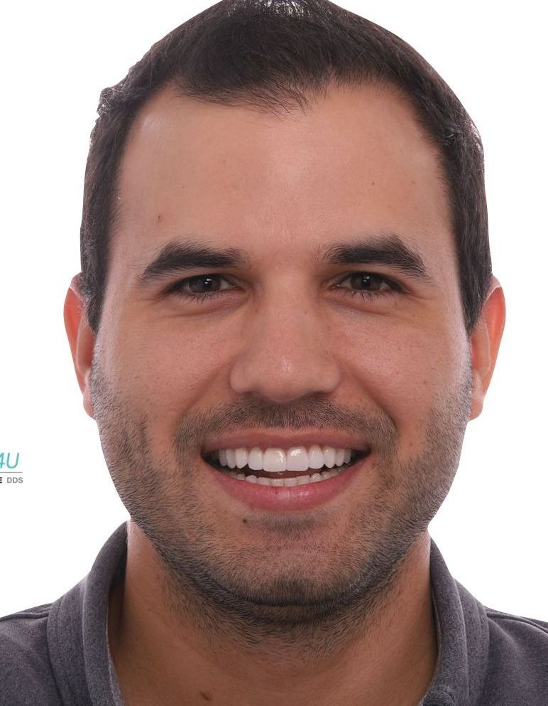 A man with a beard is smiling for the camera.