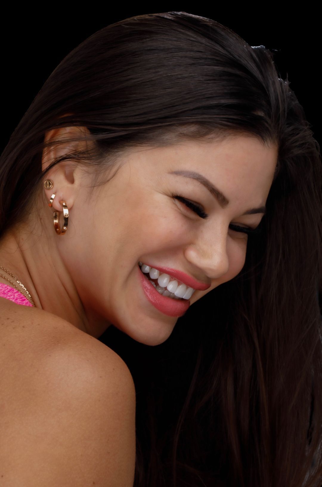 A close up of a woman 's face with a smile on her face