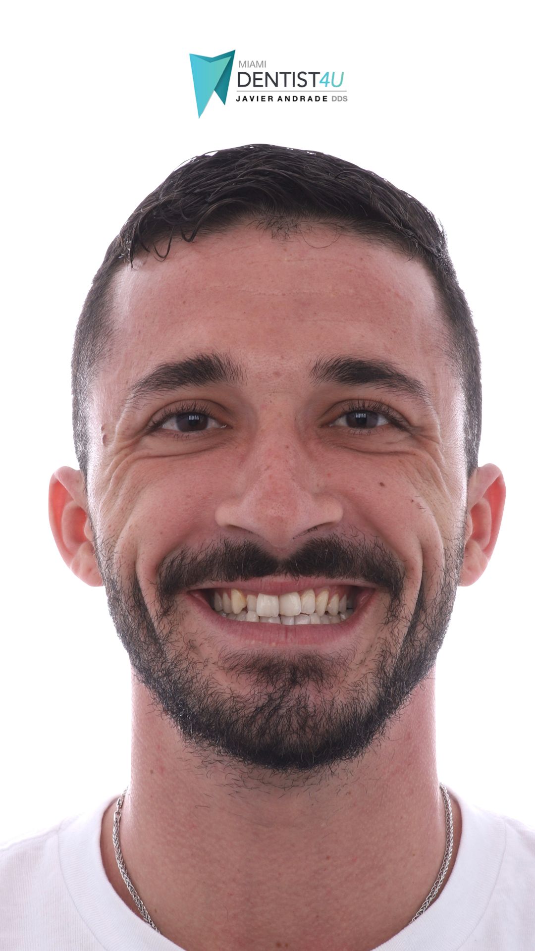 A man with a beard and mustache is smiling for the camera.