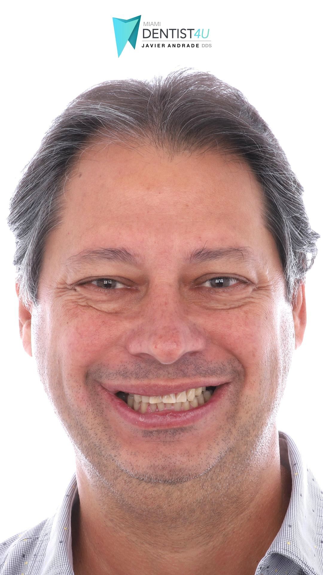 A man with a beard is smiling for the camera.