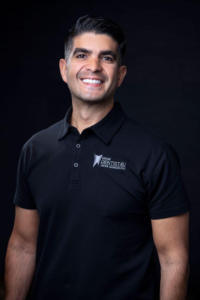 A man in a black shirt is smiling for the camera.