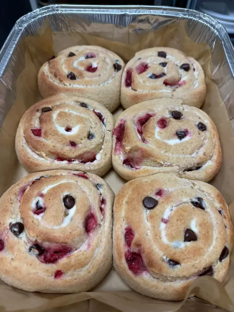 Foil tray of six berry swirl muffins with visible cranberries or chocolate chips