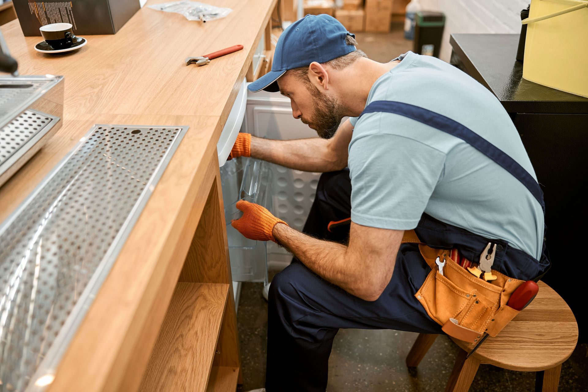 A technician is performing preventive maintenance on a commercial refrigerator.