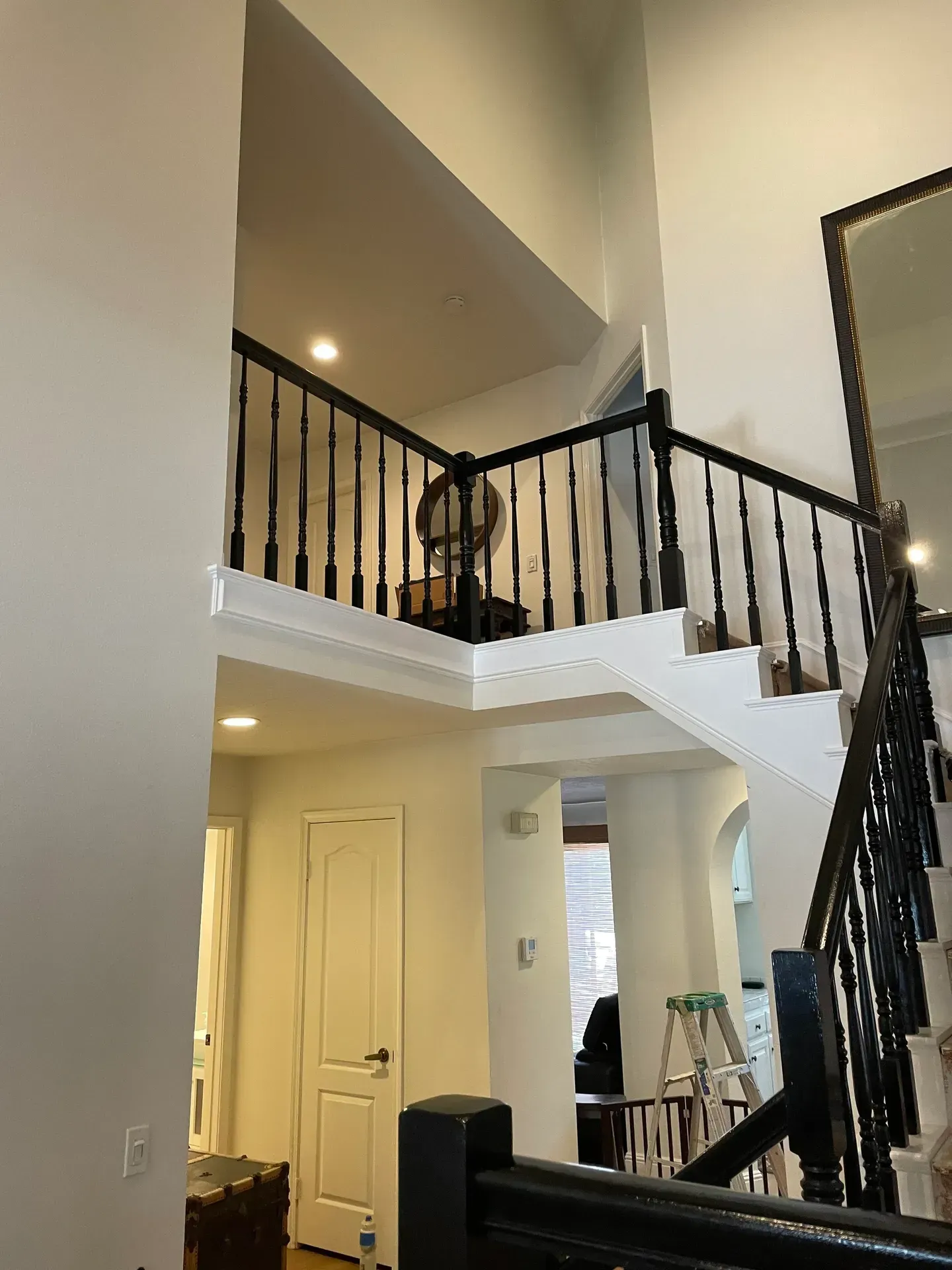 A staircase in a house with a black railing