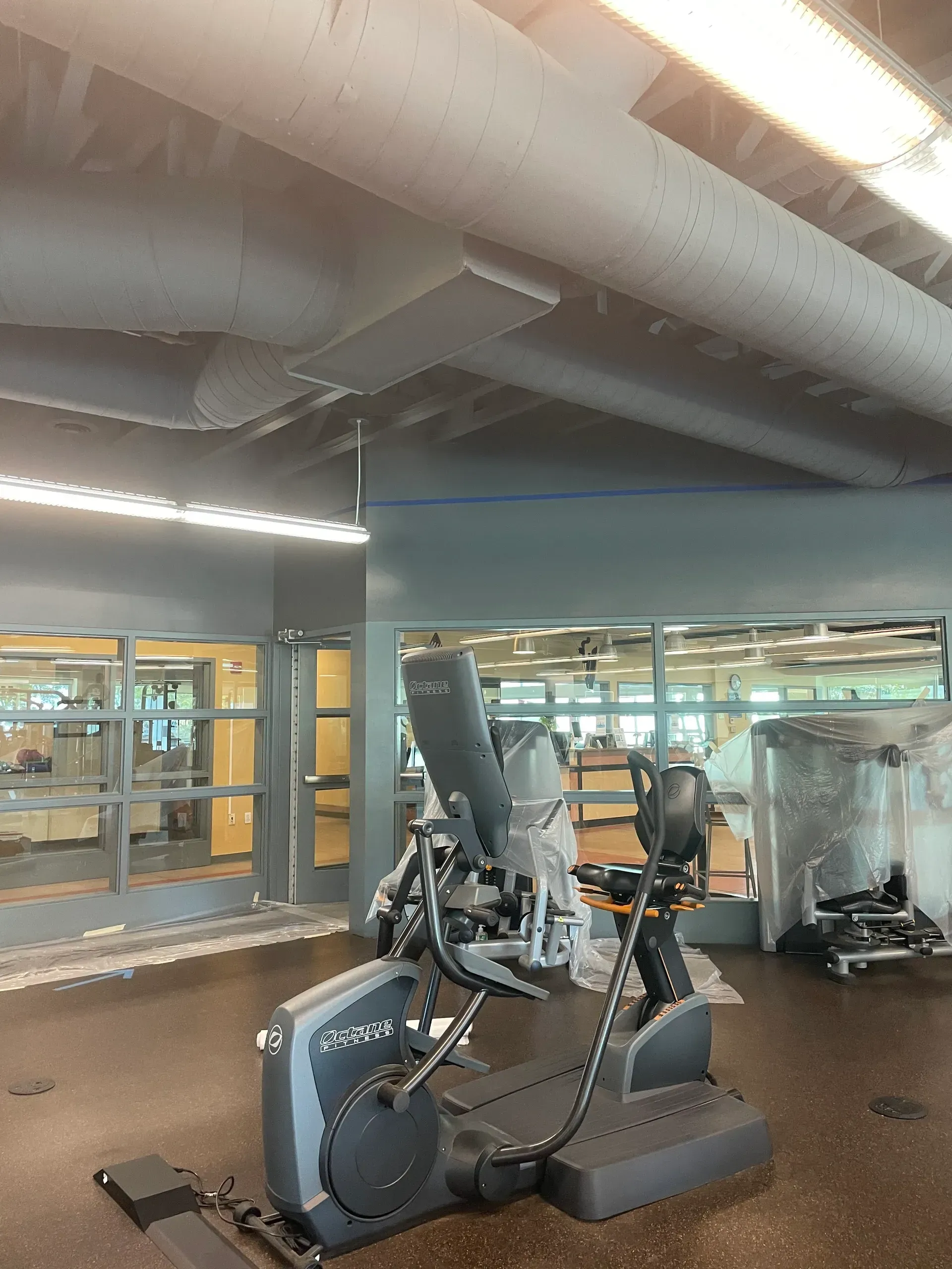 A gym with a treadmill and a bicycle