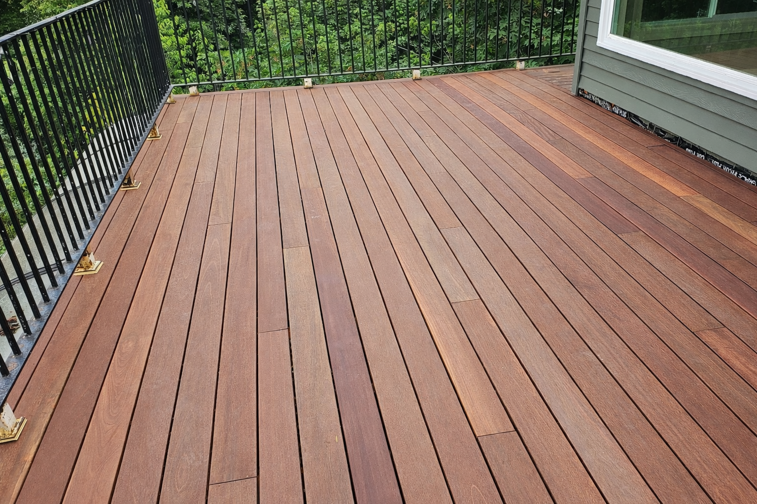 An above-ground pool with a wooden deck that has an open, unfinished gap revealing the ground below.