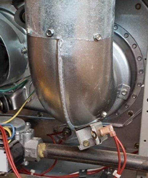 A close up of a metal pipe with wires attached to it