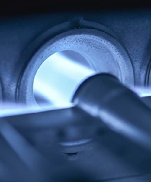 A close up of a machine with a blue light coming out of it.