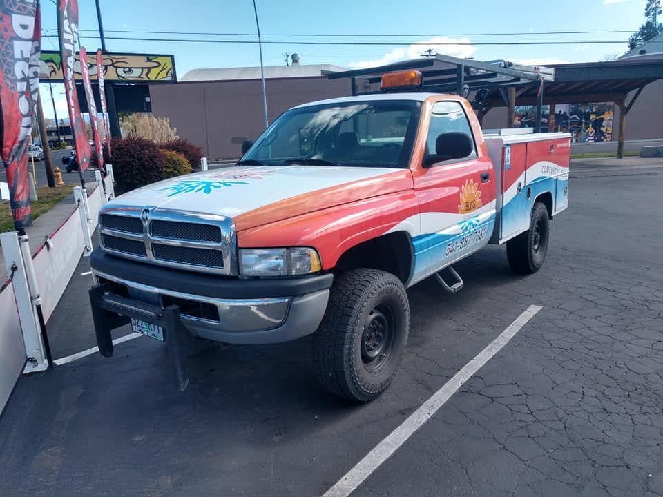 A colorful truck is parked in a parking lot.