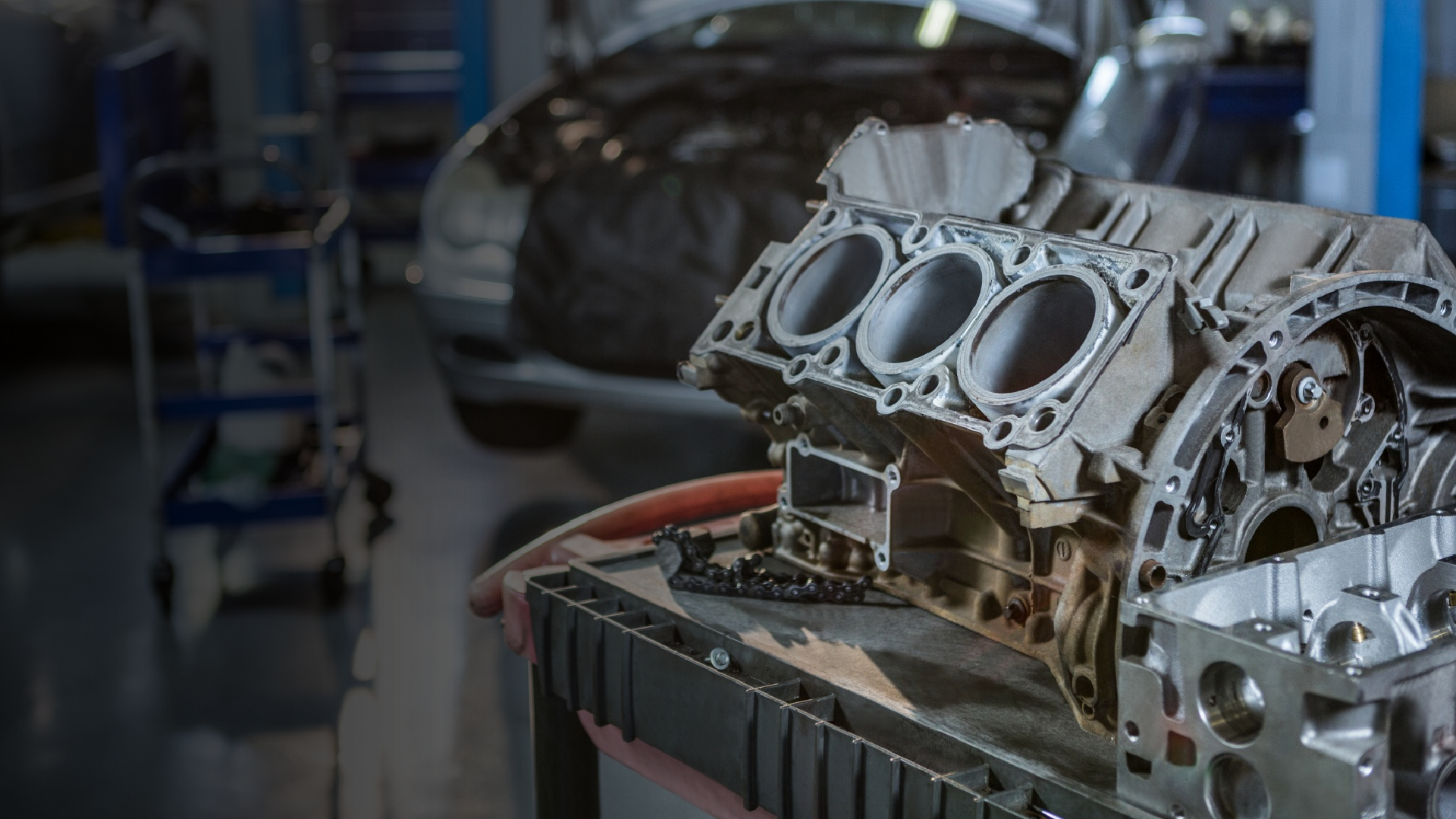 A close up of a car engine in a garage.