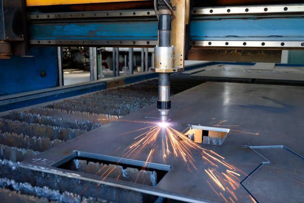 A machine is cutting a piece of metal in a factory.