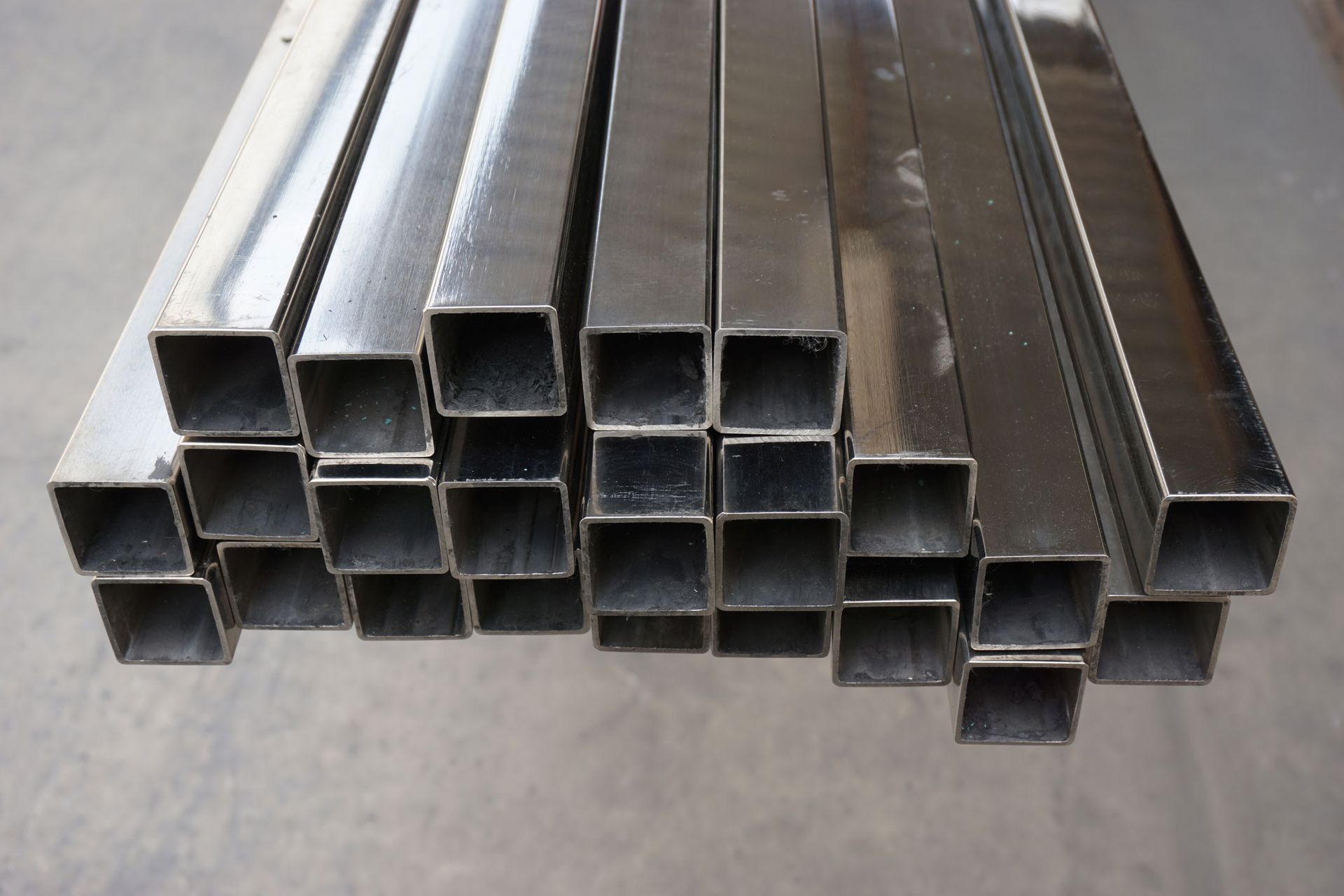 A bunch of square metal pipes stacked on top of each other