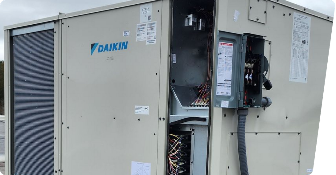 Daikin outdoor HVAC unit with exposed wiring and open service panel