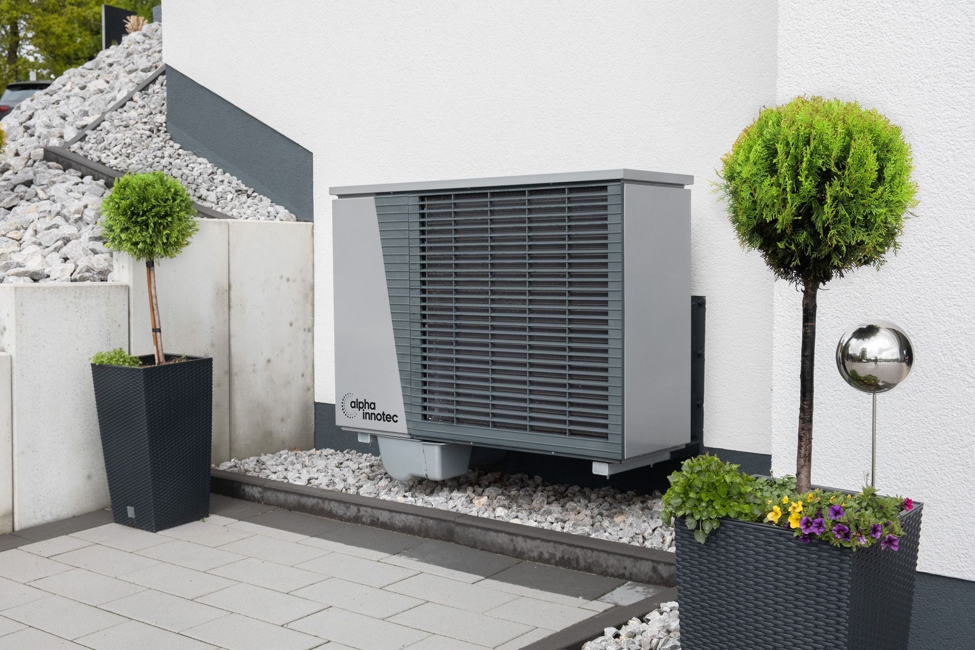 Person working on an air conditioning unit on a rooftop, with a water bottle and a white truck in the background.
