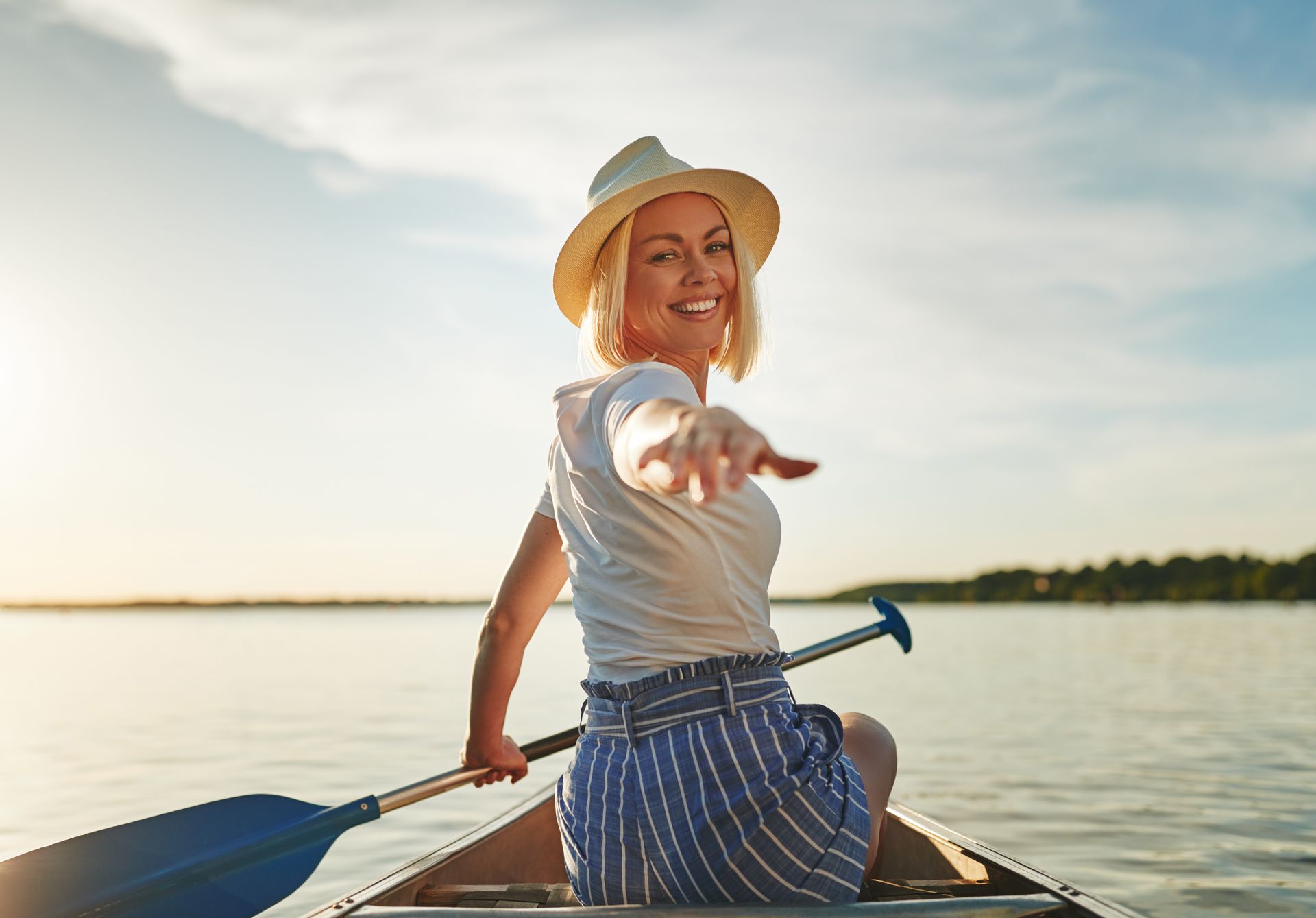 Happy woman reaching out from a canoe – take back control of your health with functional medicine by Dr. Lisa Gengo Stamford CT