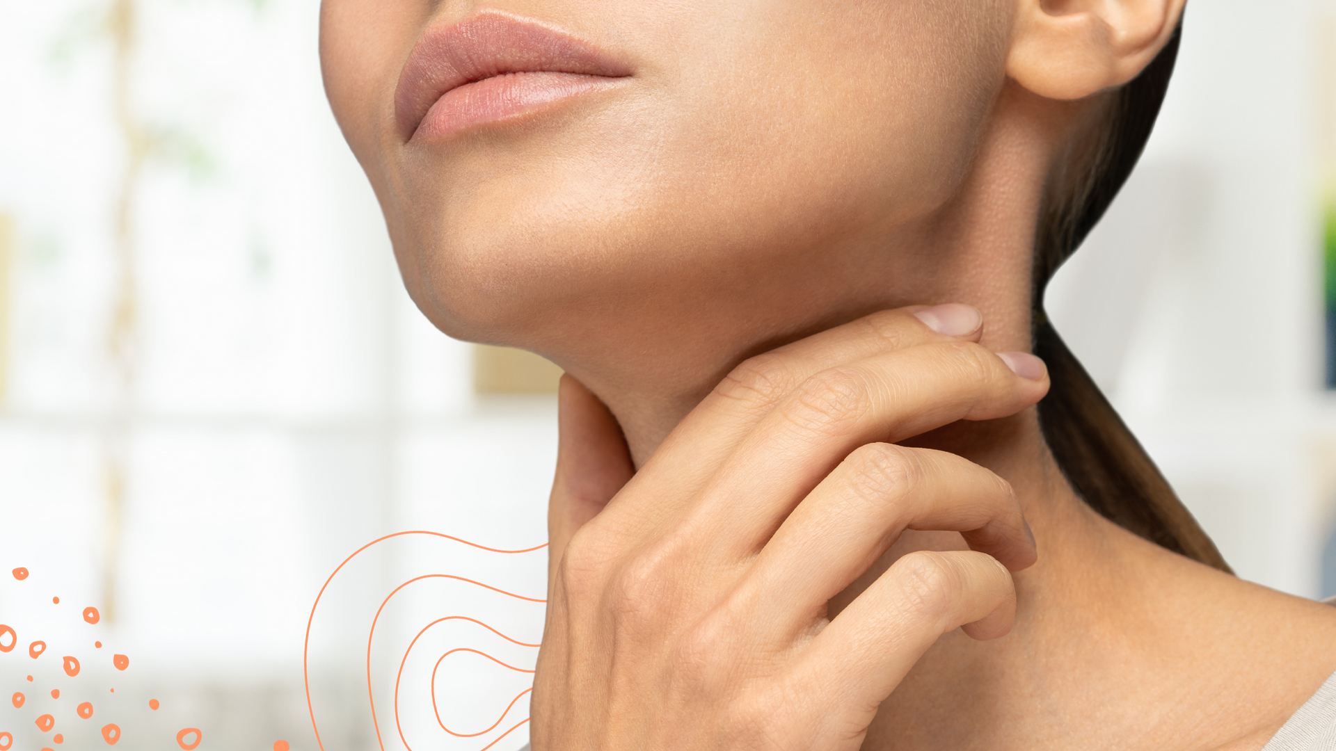 Woman with her hand softly on the front of her neck near her thyroid gland.