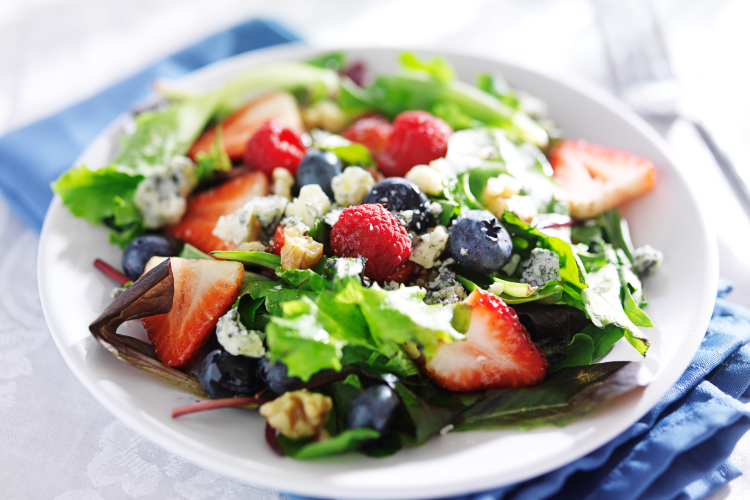 Fresh spring salad with strawberries, blueberries, and greens β healthy eating tips from Dr. Lisa Gengo functional medicine Stamford CT