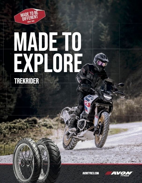 Motorcyclist on an off-road adventure bike. Tires in the foreground, text