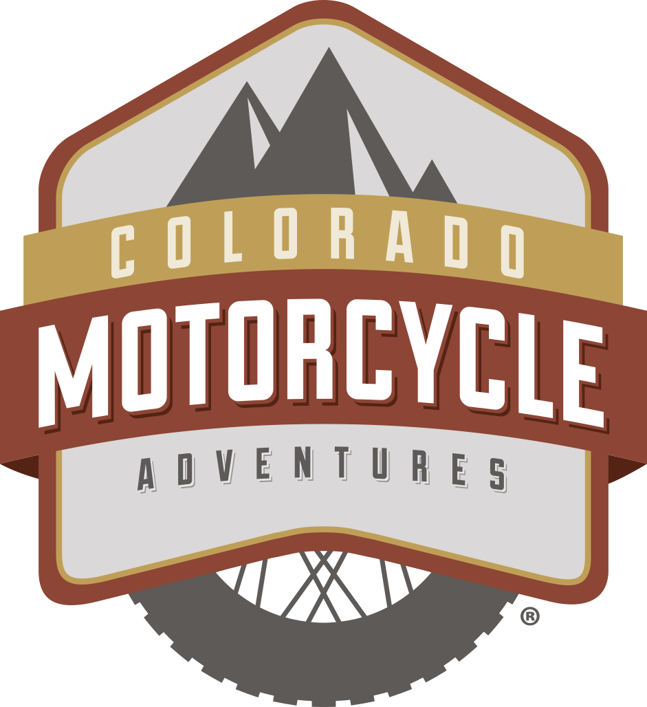 Logo for Colorado Motorcycle Adventures: a mountain scene with a motorcycle tire below.