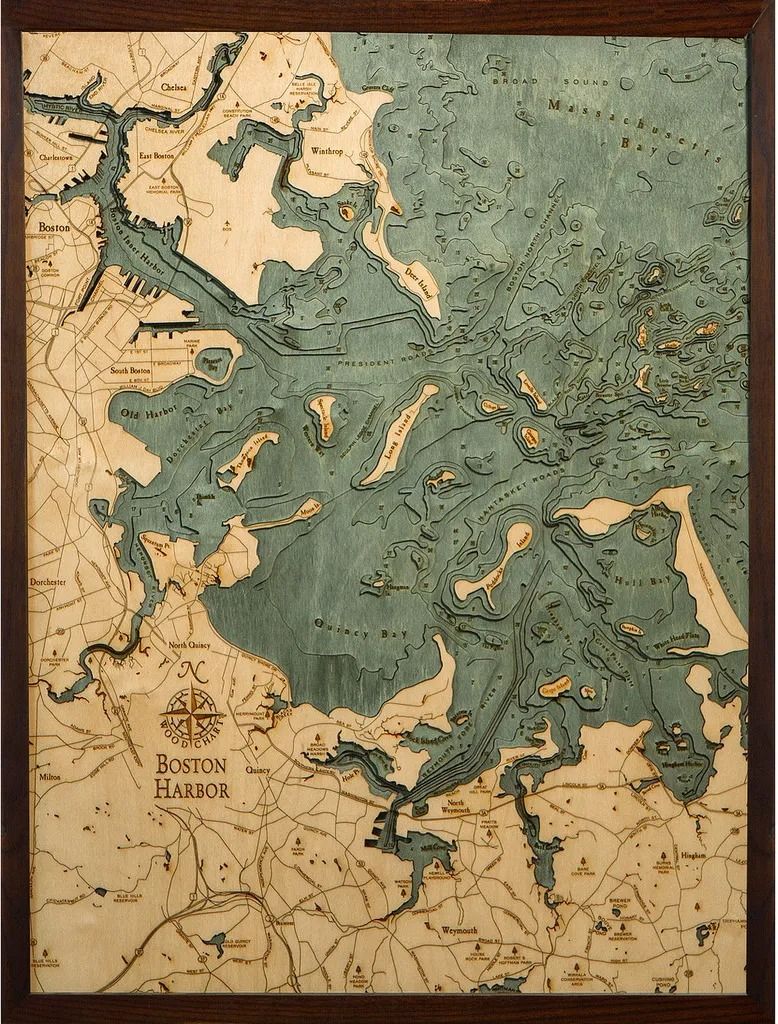 Wooden relief map of a coastal area, showing land and water in brown and teal. Framed.