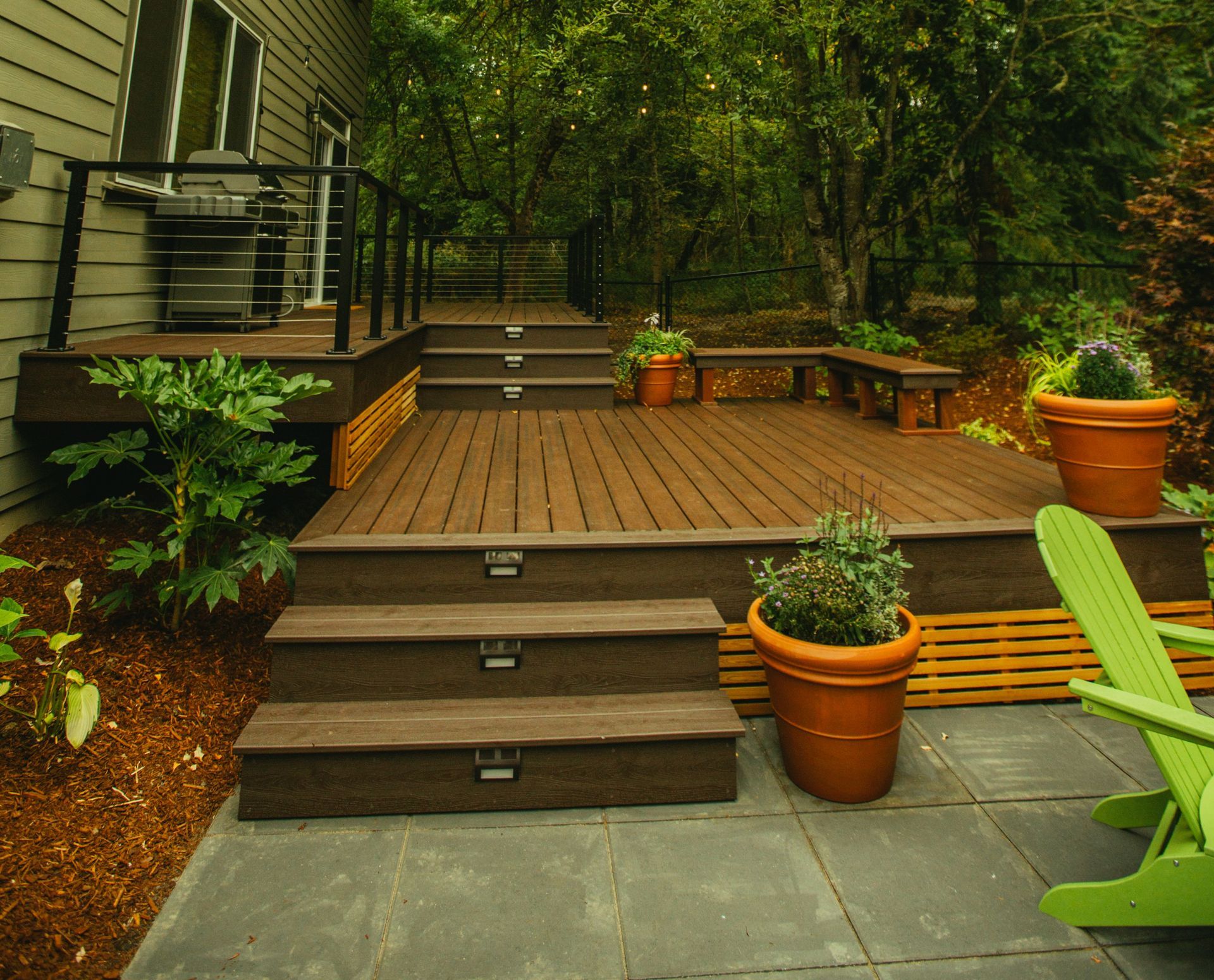 A multi-level Trex composite deck with bench seating in Jacksonville, Oregon