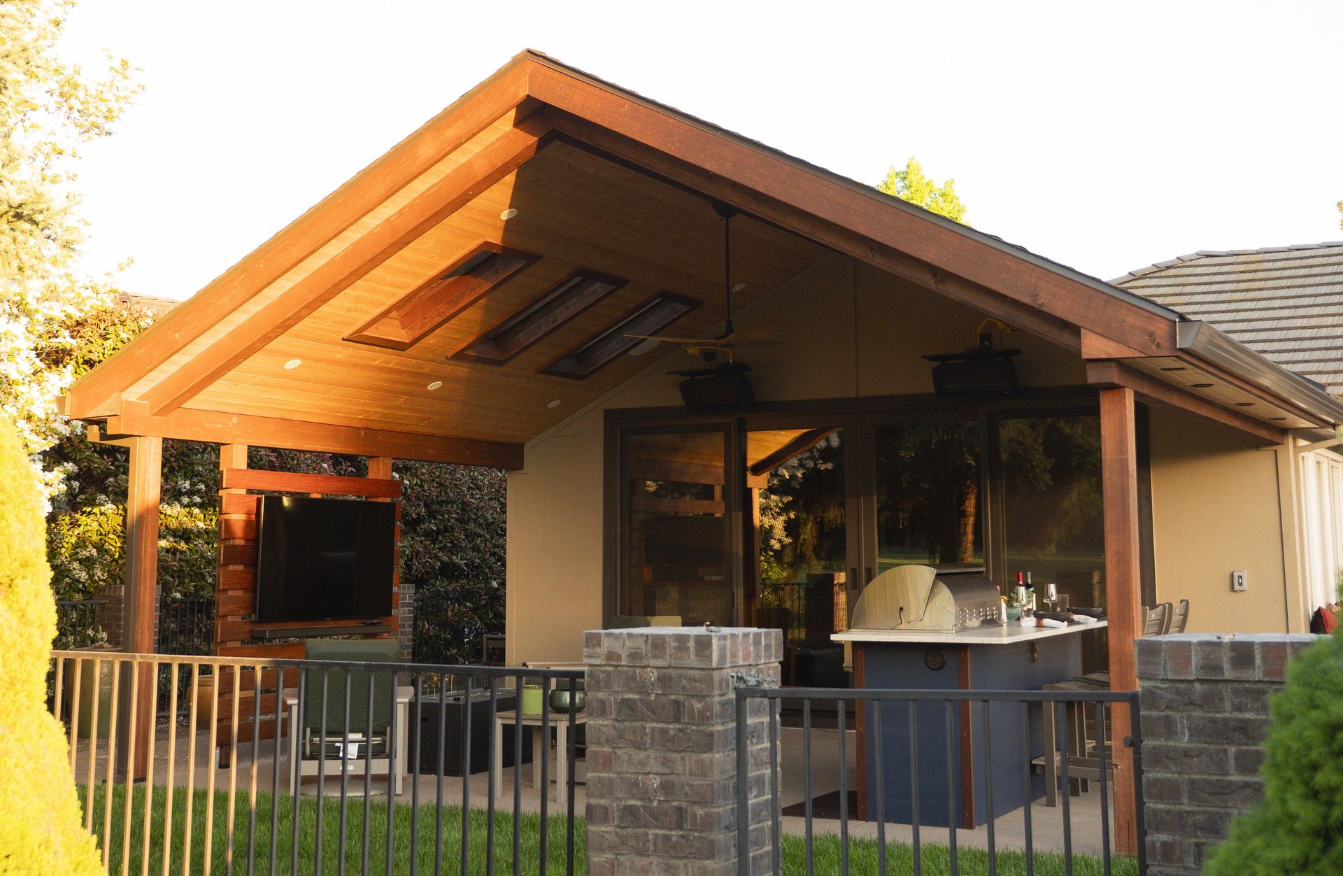 A house with a custom overhead structure to extend the outdoor living space.