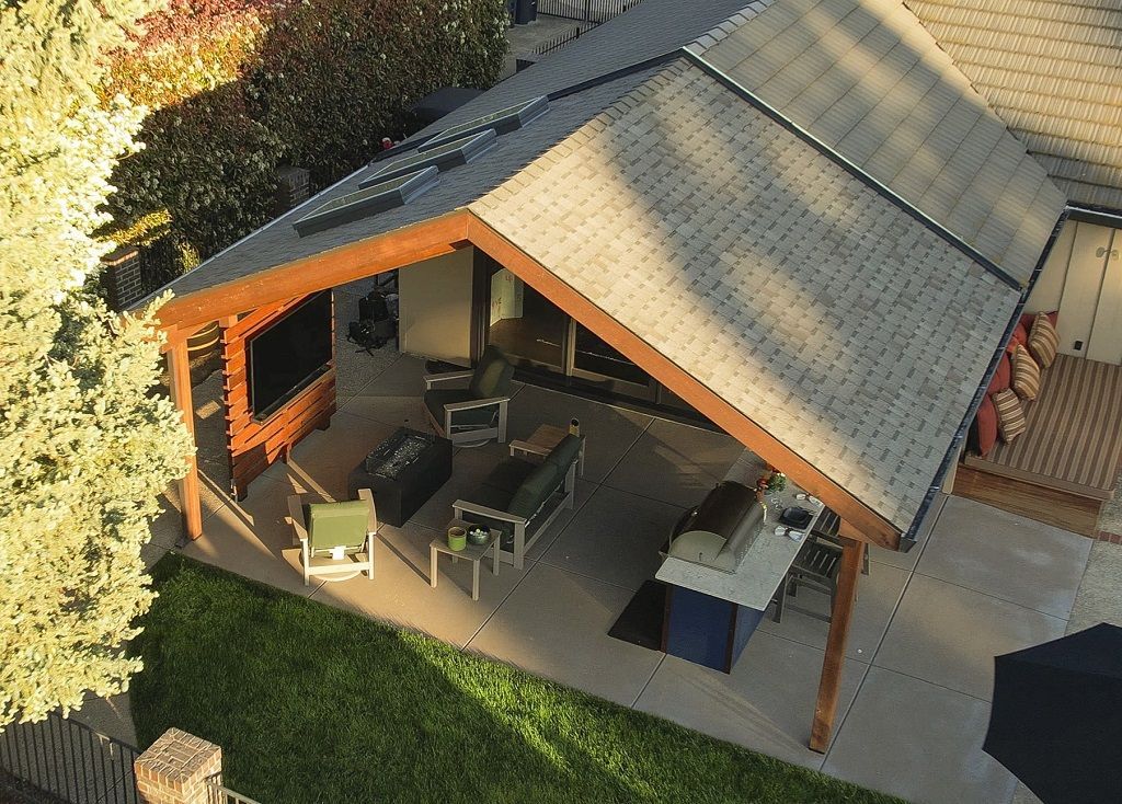 An aerial view of a house with a covered patio area
