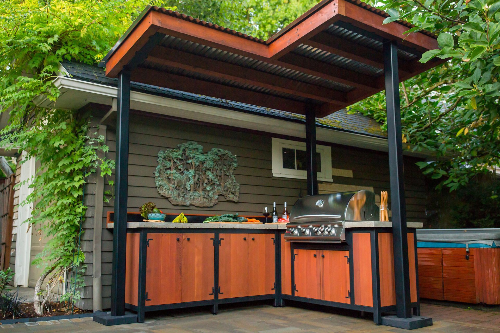 A wooden outdoor kitchen with a canopy over it