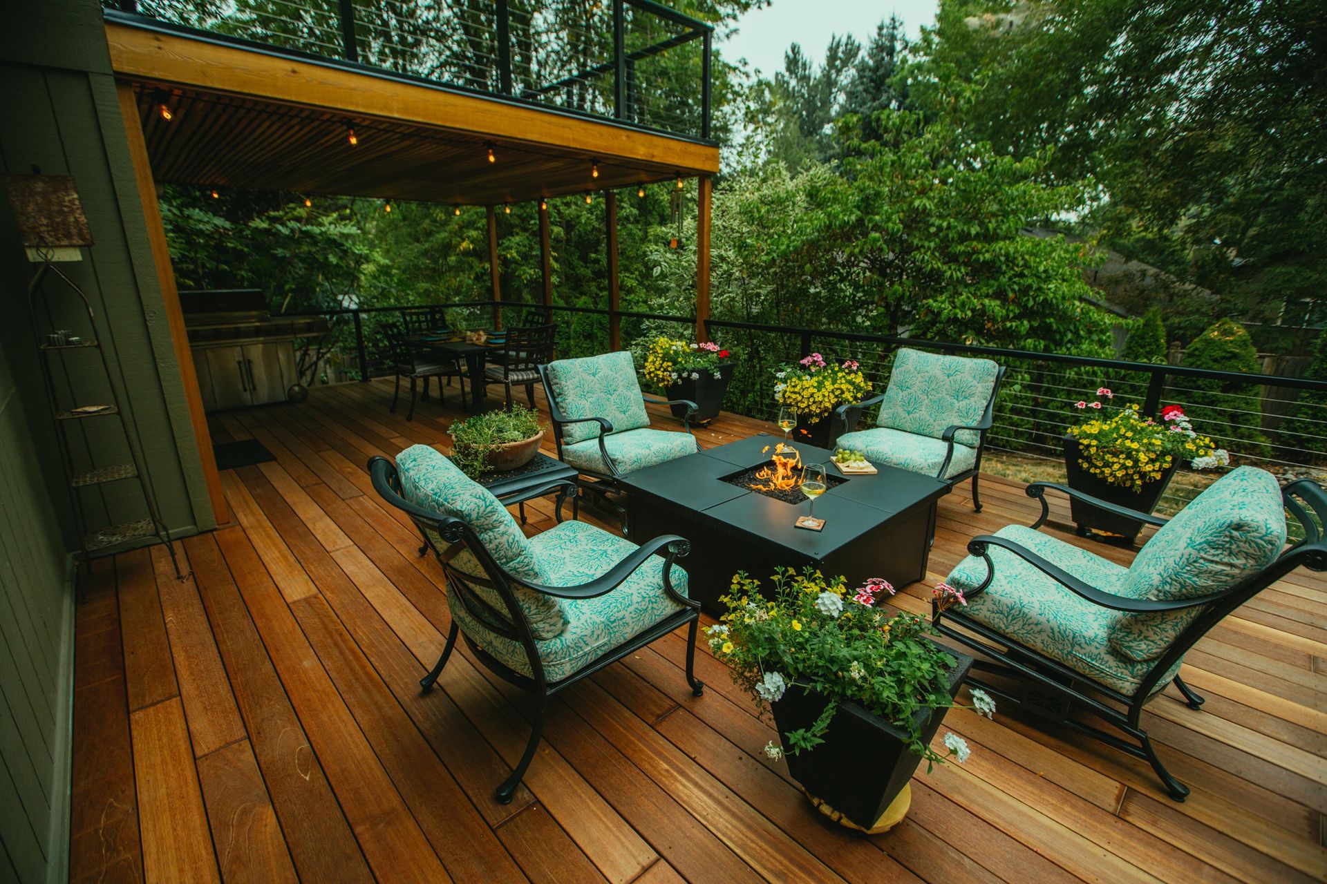 Outdoor deck with dining table, chairs, and seating area, overlooking greenery in Ashland, Oregon.