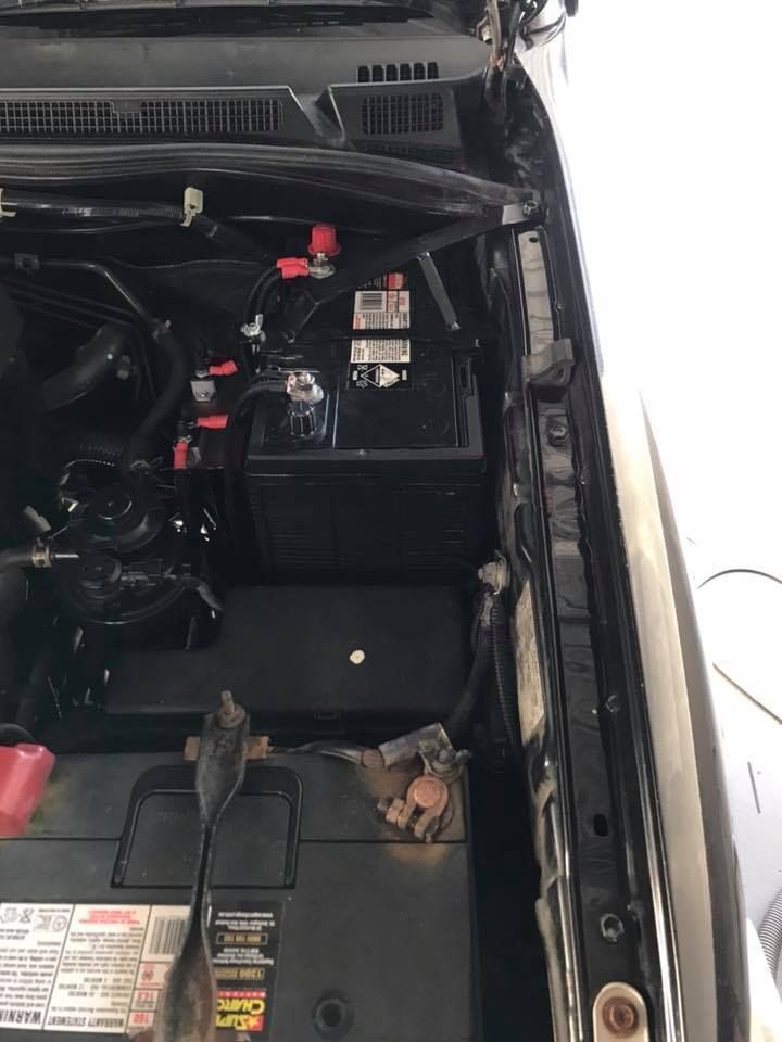 Car Engine Bay With Two Batteries, Black and Red Terminals, and Various Wires — H & E Auto Electrics in Noosaville, QLD
