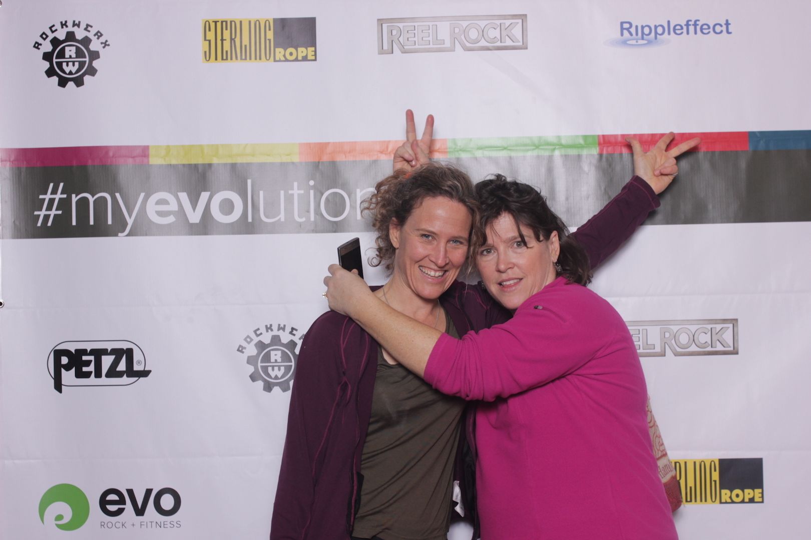 posing in front of a branded backdrop 6
