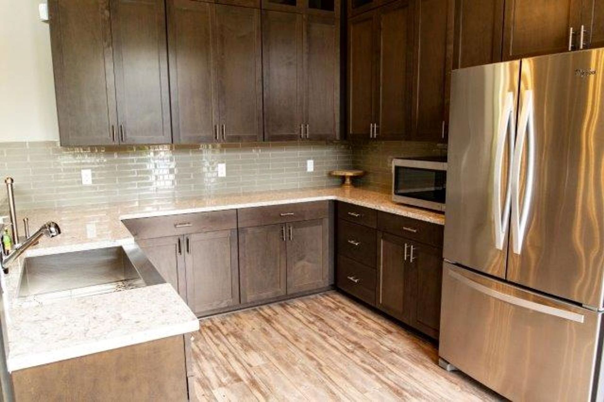 A kitchen with stainless steel appliances and wooden cabinets.
