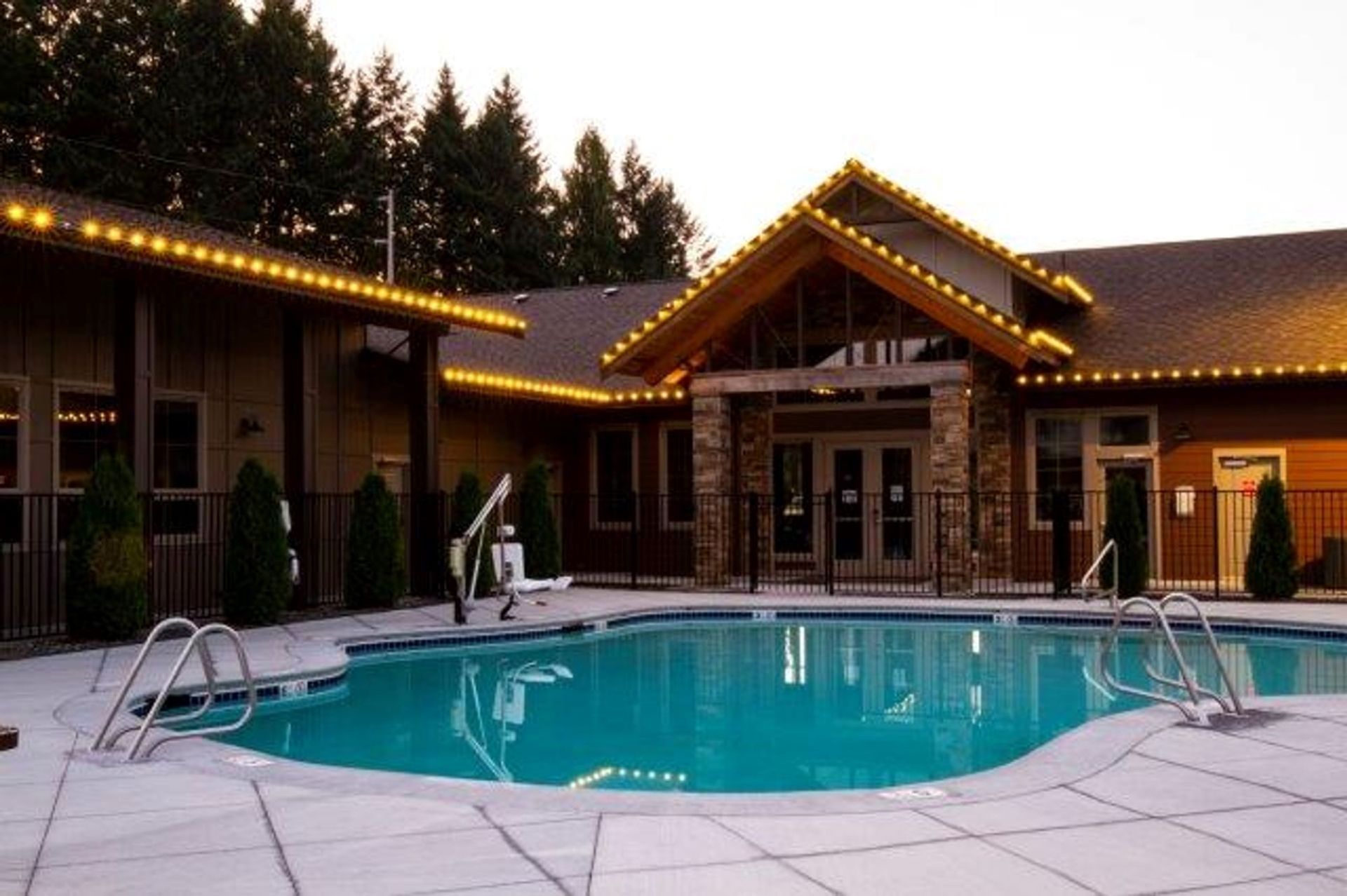 A large house with a swimming pool in front of it