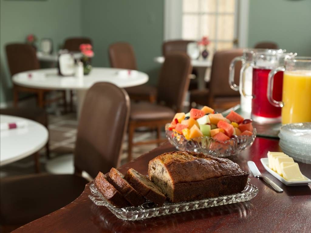 a breakfast spread with fruit, bread, and juice