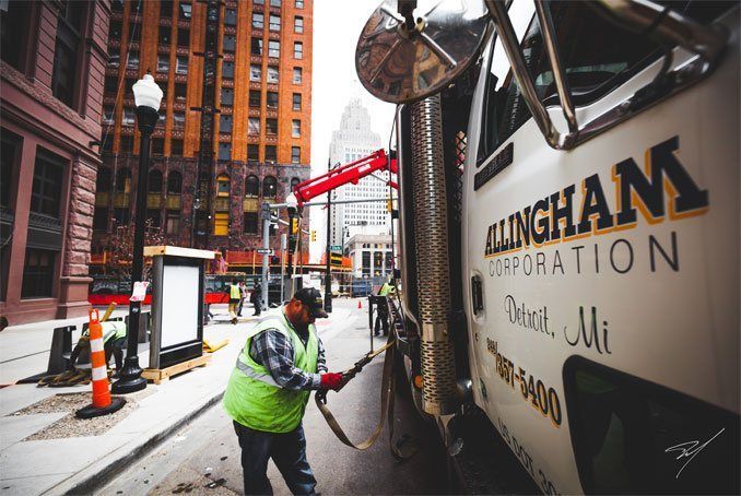 Worker Securing Equipment In City.