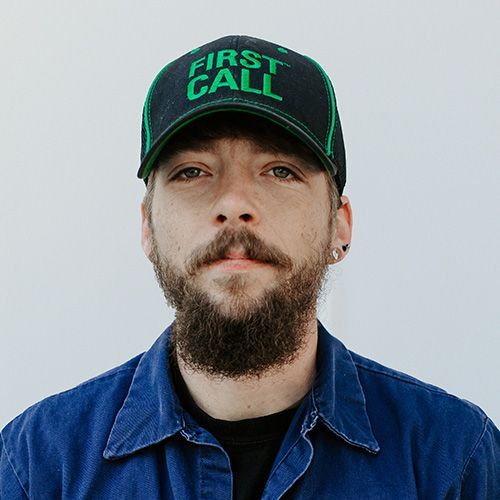 A man with a beard is wearing a first call hat.