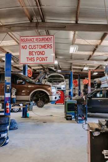 A man is working on the engine of a car.