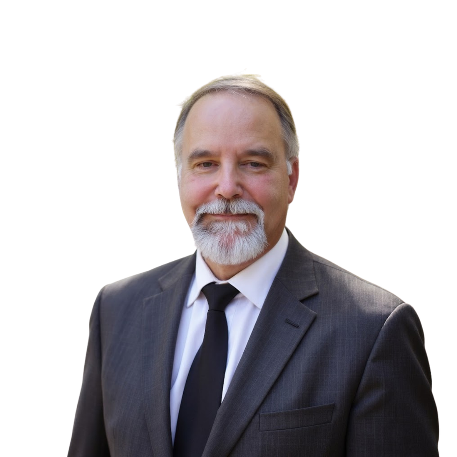 Smiling man in a dark suit and tie against a white background