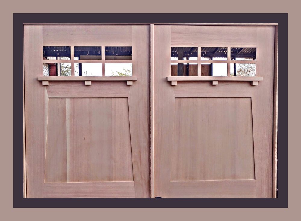 Two wooden doors with rectangular windows, natural wood finish, brown trim.