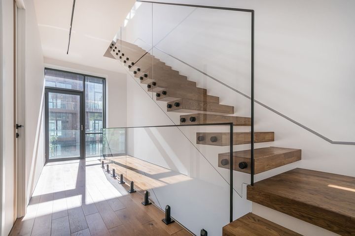 Modern stairway with glass railing in a bright minimalist interior