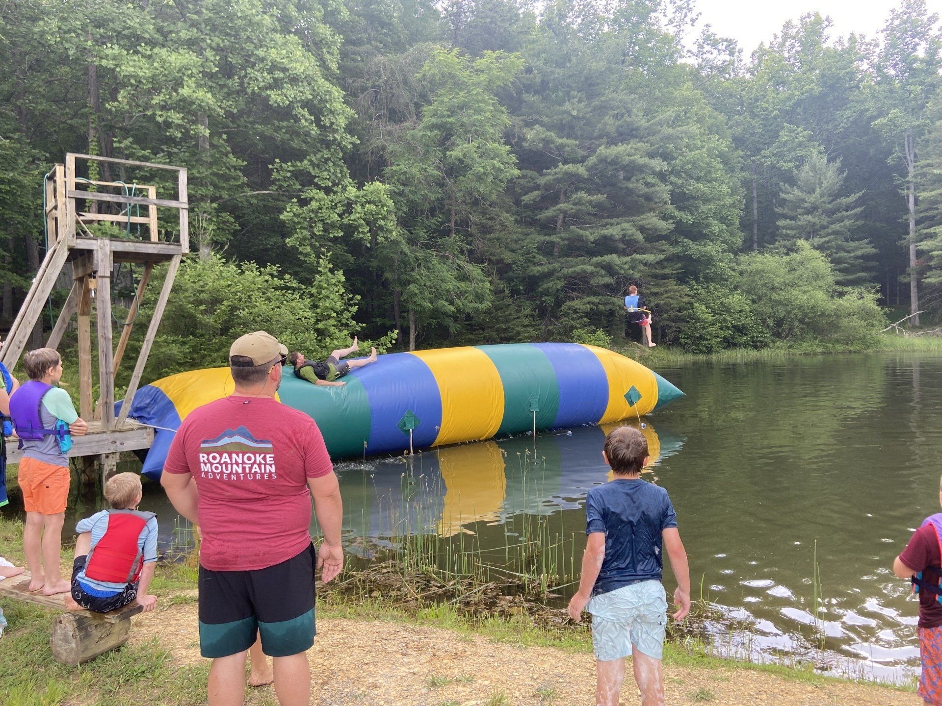people jumping on rafts at camp tukaway