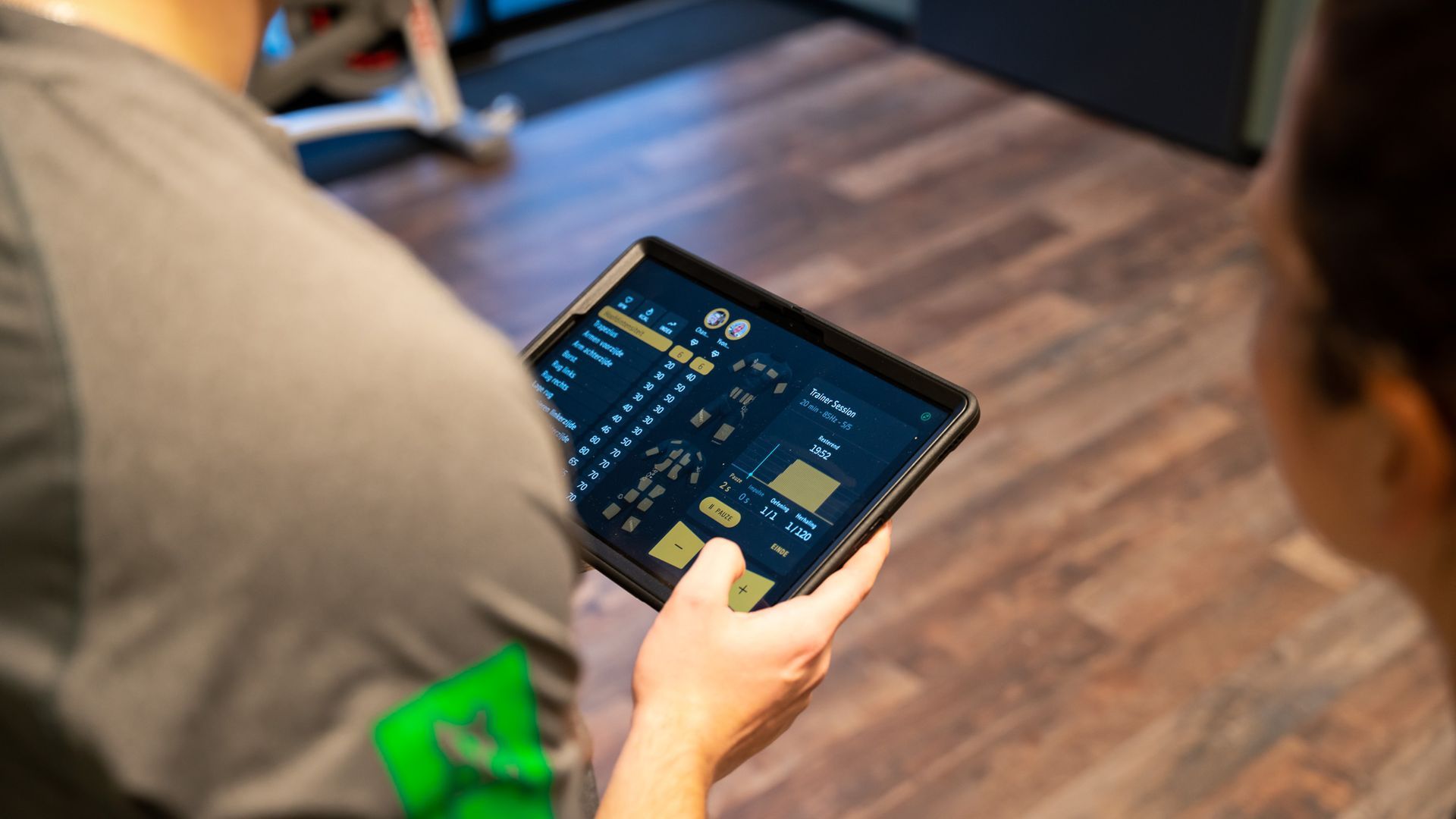 Een persoon houdt een tablet in zijn hand.