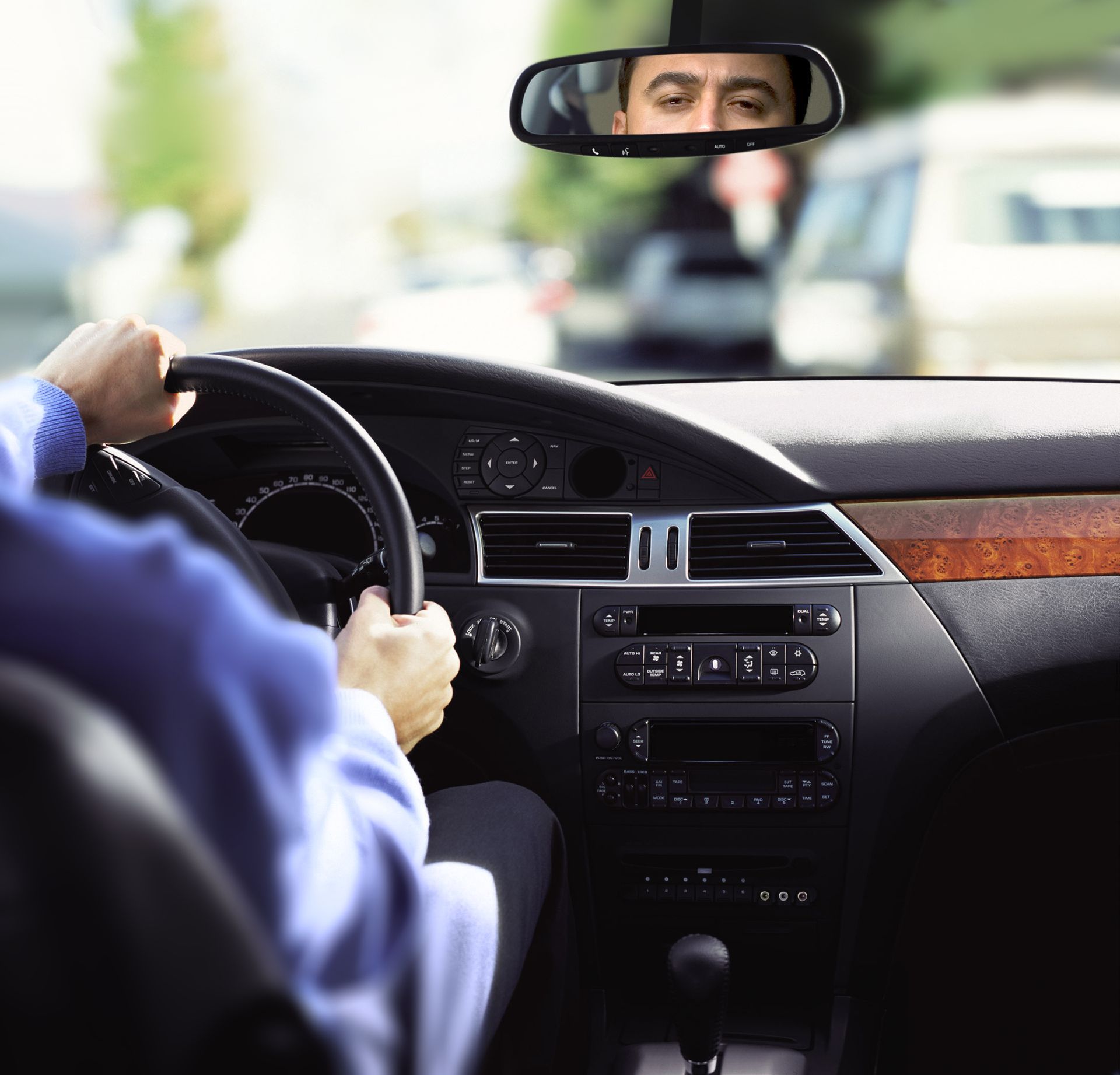 A man in a blue shirt is driving a car| Ruckersville, VA | KEL-CAM Tire & Auto