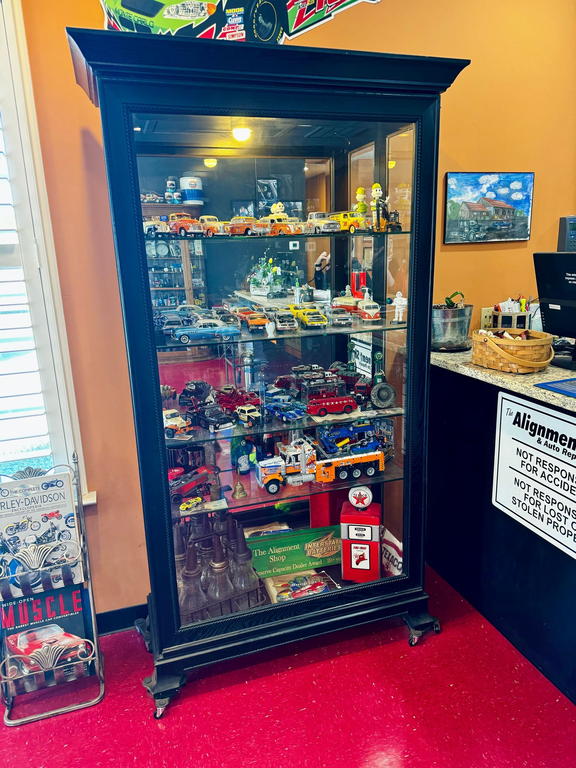 A display case filled with lots of toys and a gumball machine
