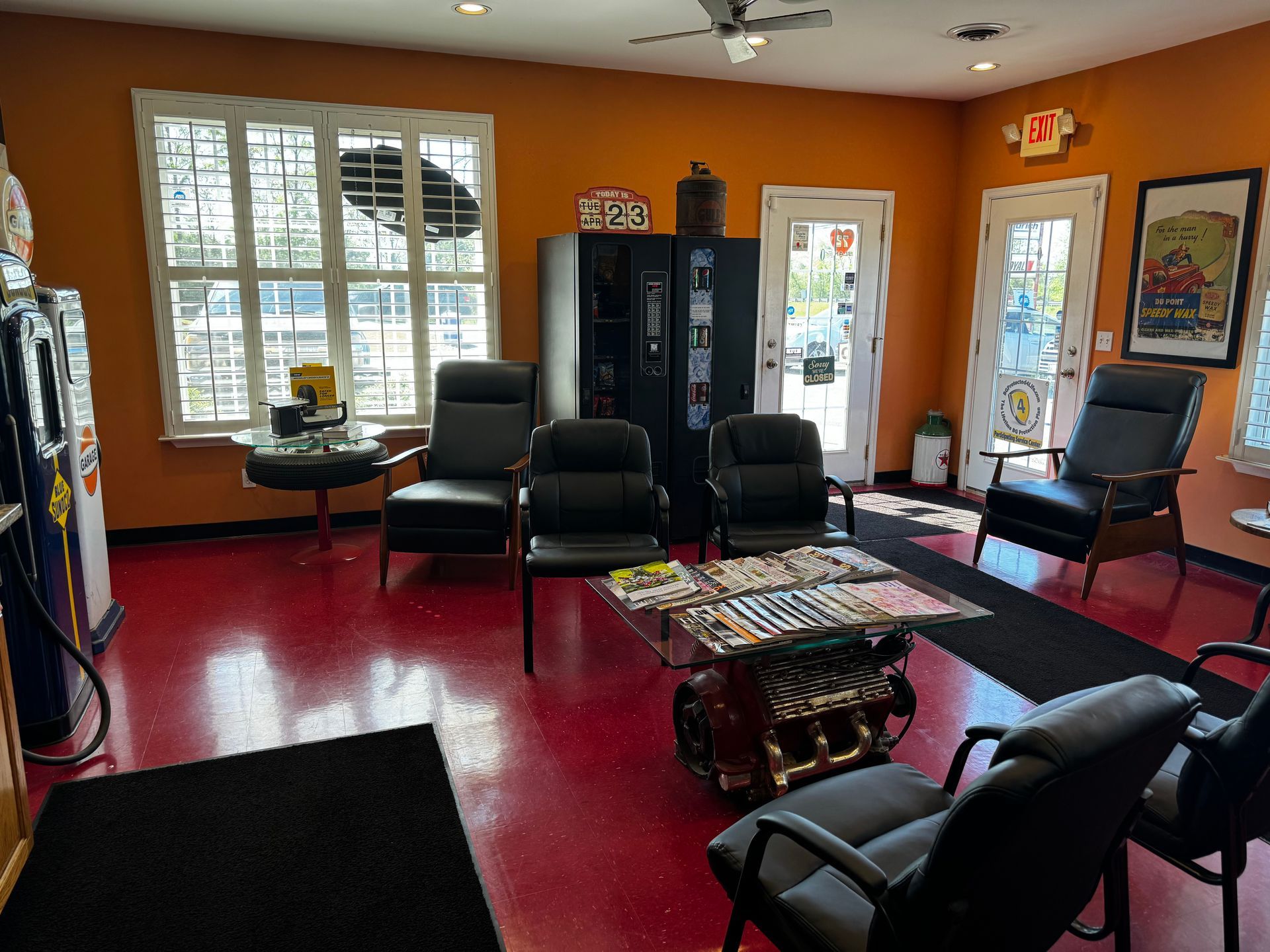 A living room with chairs , a table , and a ceiling fan.
