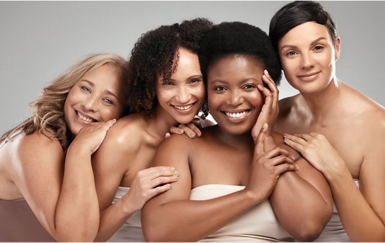 A group of women are posing for a picture together and smiling.