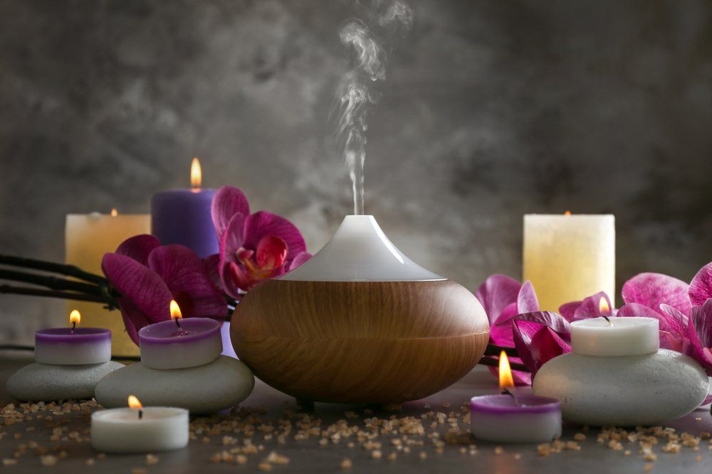 Candles & Flowers On Table — Massage Therapist in Mount Louisa, QLD