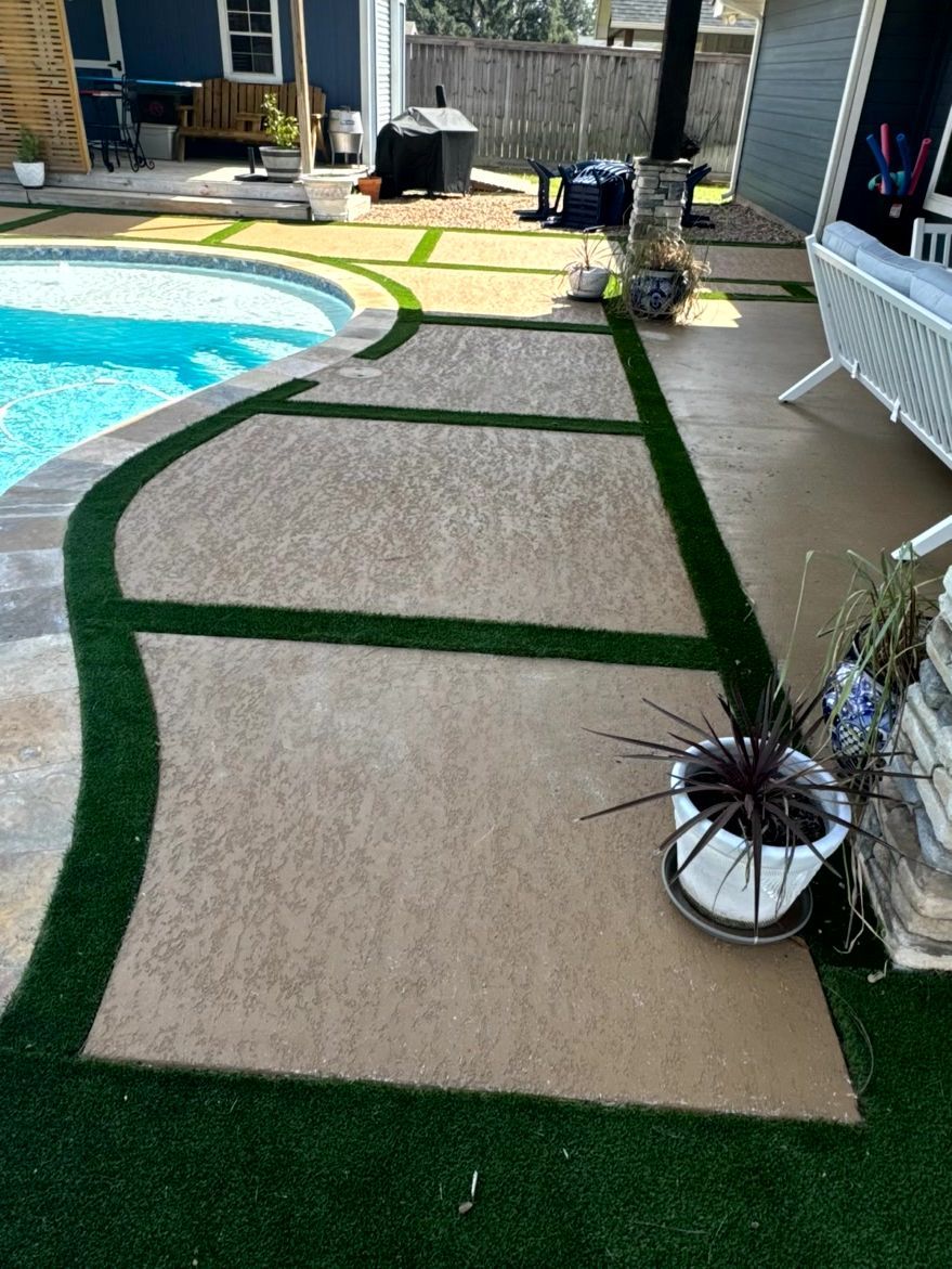 Poolside patio with tan concrete path, green borders, and pool.