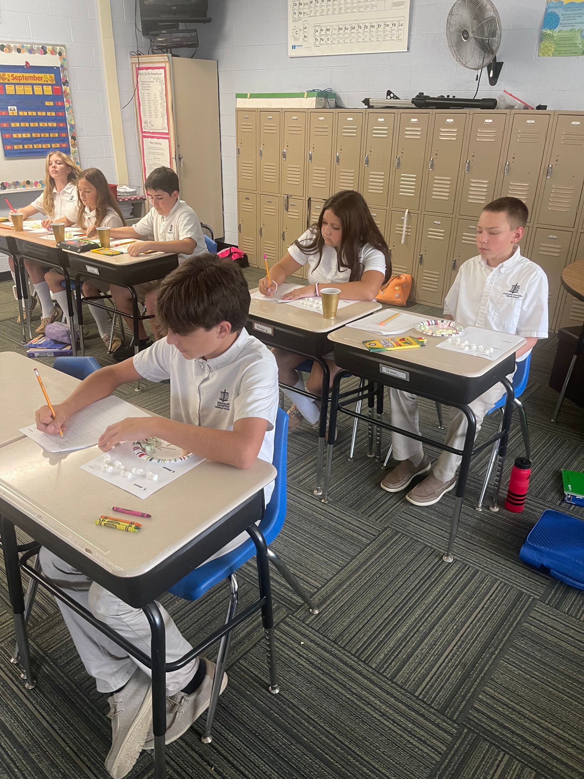 A classroom of kids working on a project.